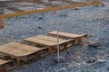 Wooden chaise lounge on the beach on a sunny day. Royalty Free Stock Photo