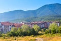 Wooden chalet hotel houses and summer mountains panorama in bulgarian ski resort Bansko, Bulgaria Royalty Free Stock Photo