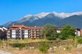 Wooden chalet hotel houses and summer mountains panorama in bulgarian ski resort Bansko, Bulgaria Royalty Free Stock Photo