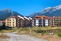 Wooden chalet hotel houses and summer mountains panorama in bulgarian ski resort Bansko, Bulgaria Royalty Free Stock Photo