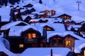 Wooden chalets covered with deep snow at blue hours