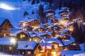 Wooden chalets covered with deep snow at the blue hours