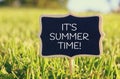 Wooden chalkboard sign with quote: IT'S SUMMER TIME