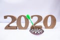 2020 wooden character with dart board, set new business goals with New Year 2020