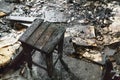 Wooden charred chair in a burnt house, consequences of a fire concept
