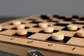 Wooden checkerboard with game pieces on light grey background, closeup Royalty Free Stock Photo