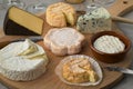 Wooden cheese board with a variety of cheeses