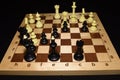 Wooden chess board and black chessmen like a strategy backdrop Royalty Free Stock Photo