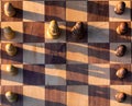 Wooden chess board with wooden pieces with sunlight Royalty Free Stock Photo