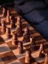 Wooden chess board with wooden pieces with sunlight Royalty Free Stock Photo
