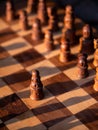 Wooden chess board with wooden pieces with sunlight Royalty Free Stock Photo