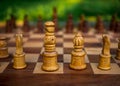 Wooden chess board with wooden pieces with sunlight. Royalty Free Stock Photo