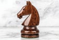 Wooden chess knight figure on marble surface Royalty Free Stock Photo