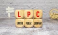 text LPC - Limited Public Company on wooden block