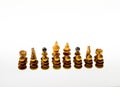 Wooden chess pieces against white background