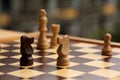 Wooden chess pieces on a cage board, skyline intentionally curved close-up, copy space Royalty Free Stock Photo