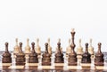 Wooden chess pieces on a chessboard, black queen and white pawns on the background, leadership retro concept Royalty Free Stock Photo