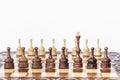 Wooden chess pieces on a chessboard, black queen and white pawns on the background, leadership retro concept Royalty Free Stock Photo