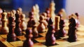 Wooden chess pieces on a chessboard, king in focus Royalty Free Stock Photo