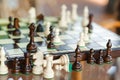 Wooden chess pieces on chessboard outdoor at the sunny day, at terrace house. Royalty Free Stock Photo