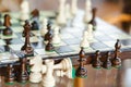 Wooden chess pieces on chessboard outdoor at the sunny day, at terrace house. Royalty Free Stock Photo