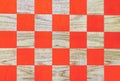 Wooden chessboard with orange cells. Checkerboard background Royalty Free Stock Photo