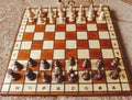 Wooden chessboard with thirty two chess pieces