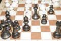 Wooden chessboard and white chessmen as a skill concept Royalty Free Stock Photo