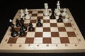 Wooden chessboard and white chessmen like a leisure theme Royalty Free Stock Photo