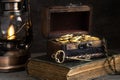 Wooden chest with gold coins and treasure key, concept of wealth, pirate treasure Royalty Free Stock Photo