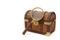Wooden chest with magnifying glass on a white background. Space for text. Royalty Free Stock Photo