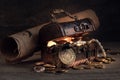 Wooden chest with wealth, pirate treasures, coins, jewellery, map on a wooden table, treasure hunting, adventure and discovery con Royalty Free Stock Photo