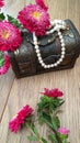 Wooden chest with white pearls and flowers Royalty Free Stock Photo