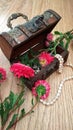 Wooden chest with white pearls and flowers Royalty Free Stock Photo