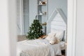 The wooden children bed with pillows and toys. Minimalistic Christmas decor. Scandinavian interior