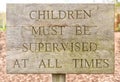 Wooden children must be supervised sign Royalty Free Stock Photo