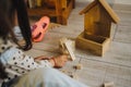The girl builds a tower out of a wooden construction kit. Children`s room Royalty Free Stock Photo