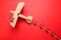 Wooden children`s plane on a red background Royalty Free Stock Photo