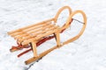 Wooden children sled in winter snow