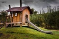 Wooden childrens playhouse with slide Royalty Free Stock Photo