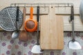 Wooden chopping block with kitchenware hang at the kitchen wall Royalty Free Stock Photo