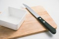 Wooden chopping block, knife, bowl, kitchenware on cutting board Royalty Free Stock Photo