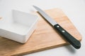 Wooden chopping block, knife, bowl, kitchenware on cutting board Royalty Free Stock Photo