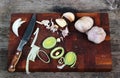 Wooden chopping board with knife. Peeled garlic and scraps of on