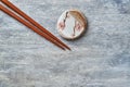 Wooden chopsticks and chopstick rest on rustic wooden background. Top view. Royalty Free Stock Photo