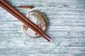 Wooden chopsticks and chopstick rest on rustic wooden background. Top view. Royalty Free Stock Photo