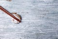 Wooden chopsticks and chopstick rest on rustic wooden background. Top view. Royalty Free Stock Photo