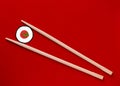 Wooden chopsticks on a red background