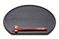 Wooden chopsticks on red lacquer tray Royalty Free Stock Photo