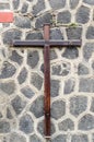 Wooden christian cross on a grey stone wall Royalty Free Stock Photo